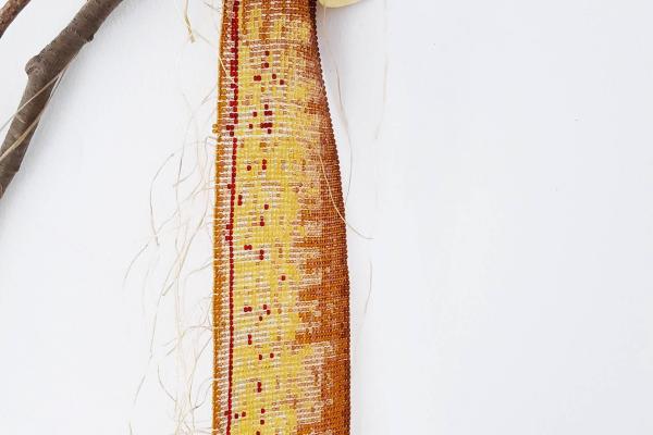 sculpture made of beads, cedar and hide
