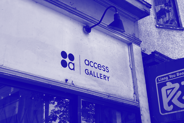 A duotone photo in royal blue of the Access Gallery logo painted on the storefront of the building. 