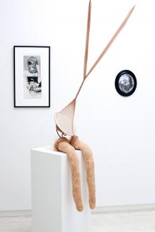installation view of sculptures and photographs in a gallery space