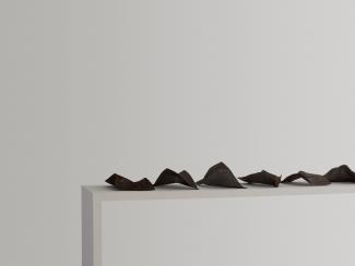 a row of bent steel plates, rusted