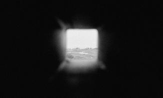 Film still from Curtis Grauher's Giant Head.  Black and white blurry image. 