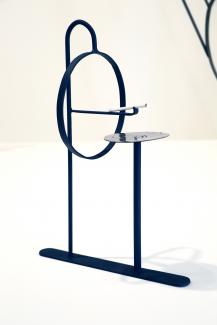 metal sculptural cigarette holder with cigarette