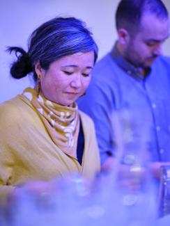 Two concentrating bartenders in blue light
