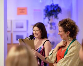 Two people smiling, making opening remarks