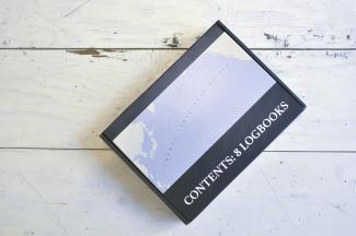 image of a shipping box labelled "contents: 8 logbooks"