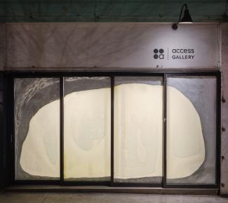 Exterior window shot at night time of 'slippery pool of time' by Tiffany Law. 